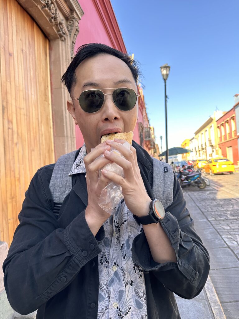 Indulge in freshly prepared tamales from a Oaxaca street vendor, offering a rich mix of flavours wrapped in corn husks, a true taste of Oaxacan culture