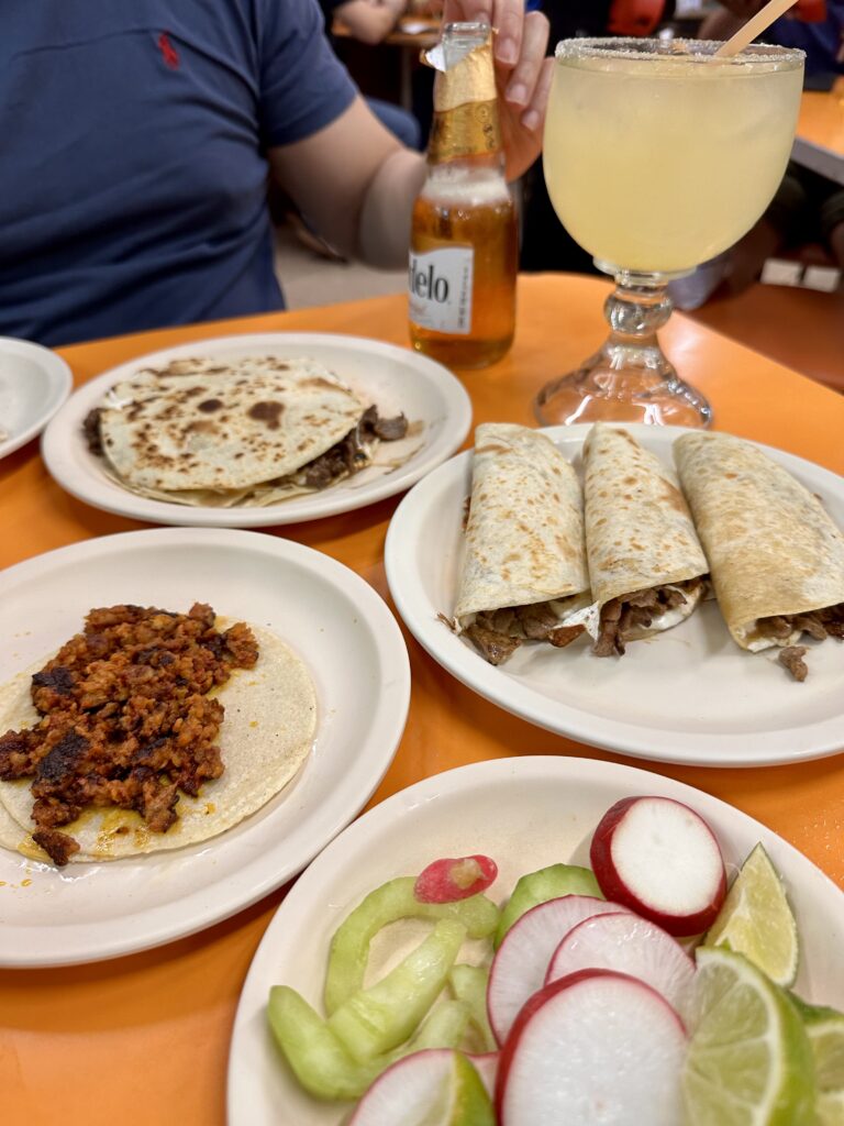 Mouthwatering carne asada tacos with lime wedges and fresh toppings – top tacos in Mexico.