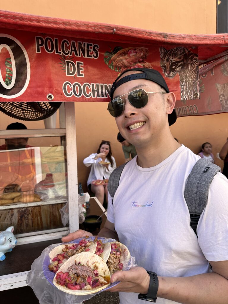Enjoy the flavourful cochinita pibil tacos topped with fresh ingredients at El Tigrillo stand in Valladolid, offering a true taste of Yucatán cuisine