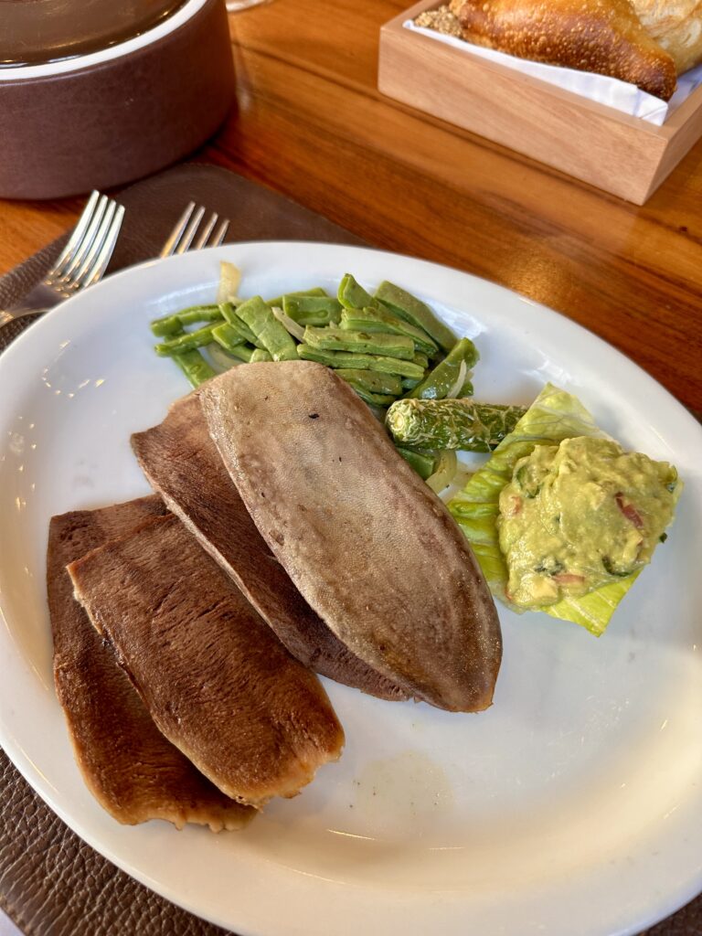Indulging in melt-in-your-mouth beef tongue at El Cardenal, a true taste of traditional Mexico City flavors paired with cactus. A must try!