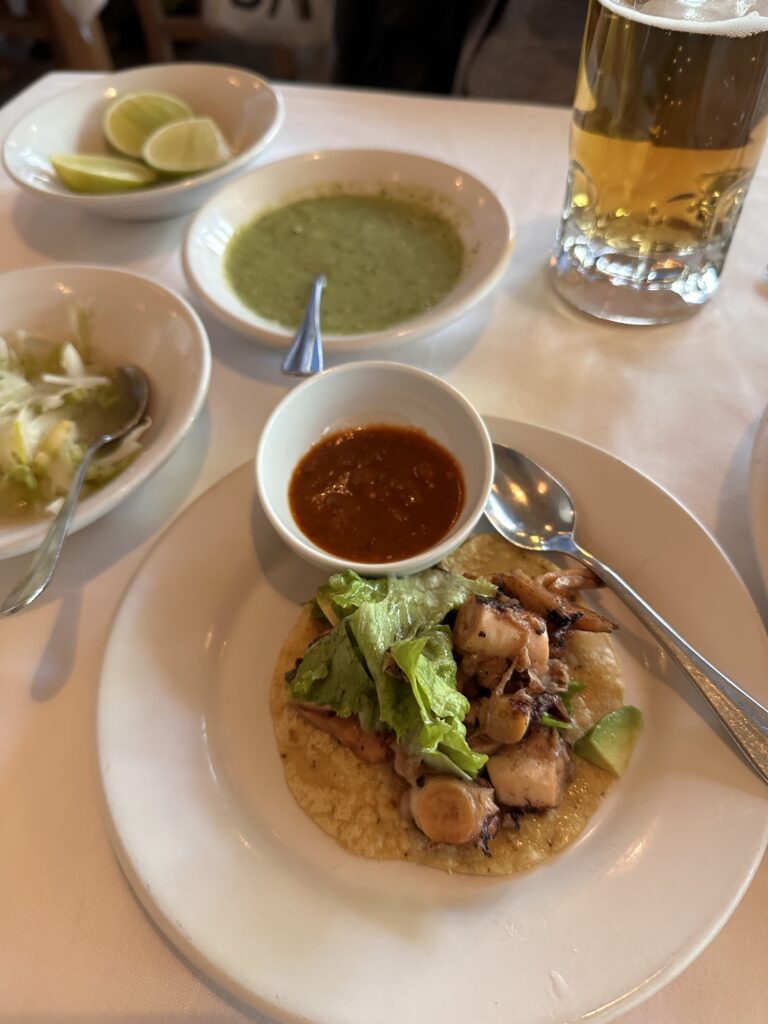 Perfectly charred octopus taco at Contramar, paired with zesty lime and house-made salsa in Mexico City.