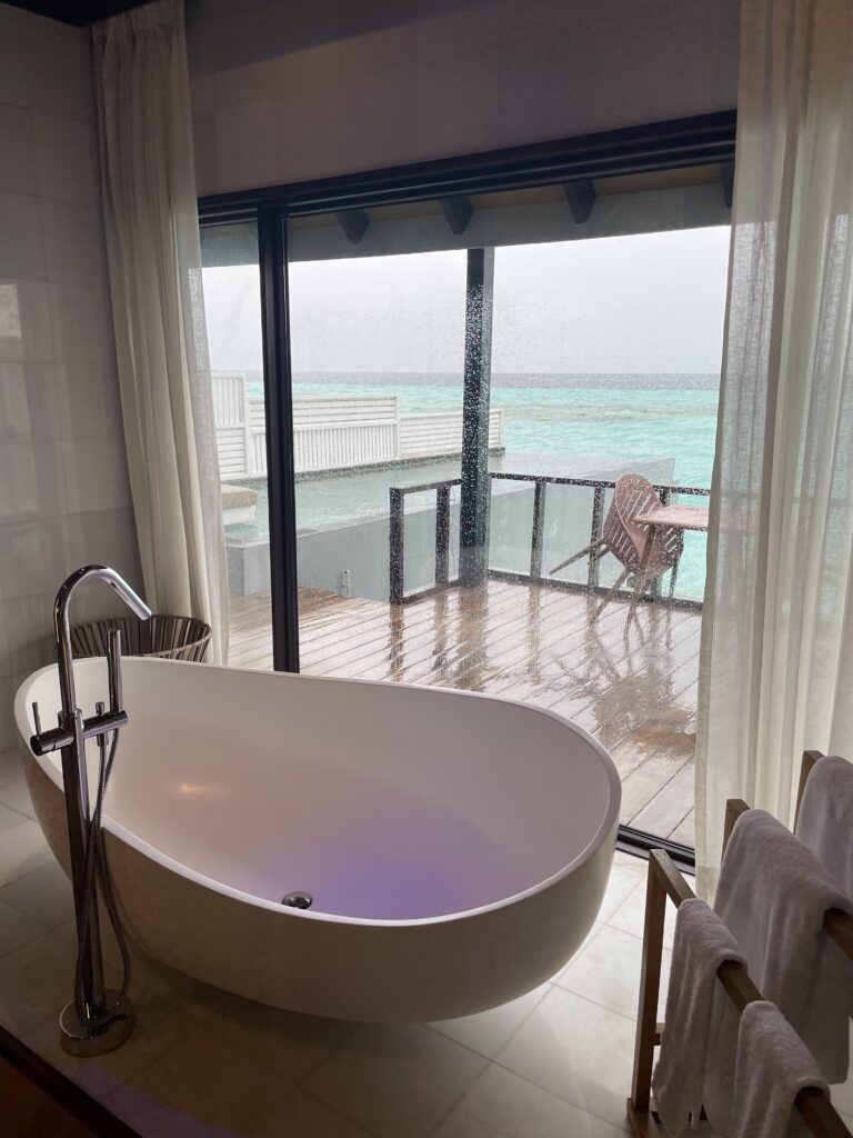 Relaxing in a luxurious Wind Villa at Ozen Life Maadhoo – watching the rain patter away from the comfort of your magnificent overwater villa.