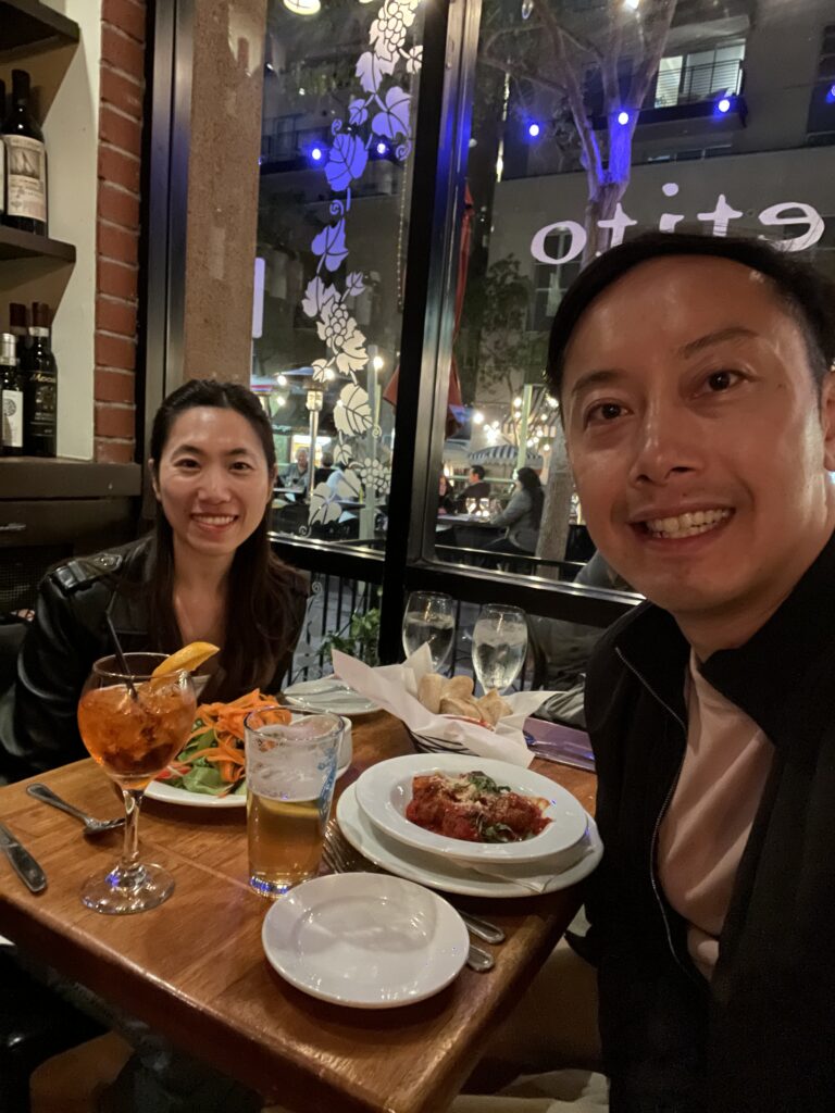 Couple enjoying a cozy Italian dinner with pasta and spritz at Buon Appetito