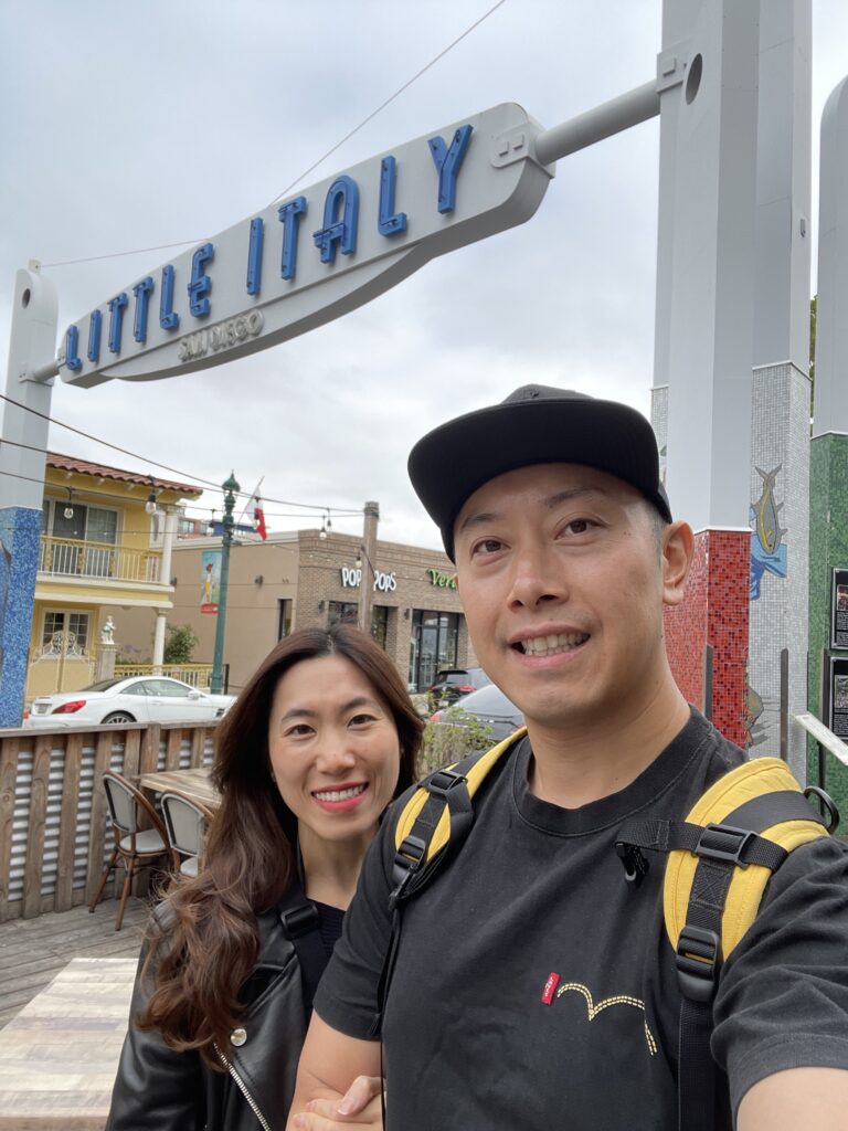 Visitors enjoying a stroll through the vibrant streets of Little Italy in San Diego