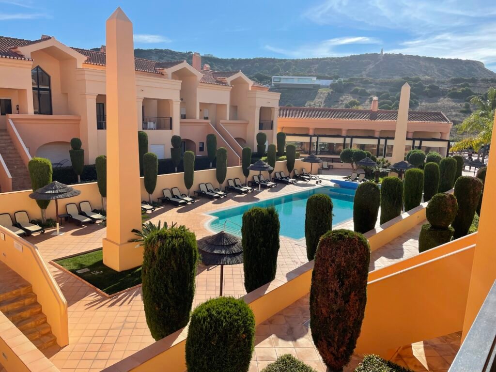 Swimming pool and sun loungers at Baía da Luz family-friendly resort in southern Portugal