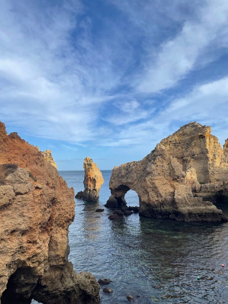 Sunlight illuminating sea stacks and arches at Ponta da Piedade, Algarve coast