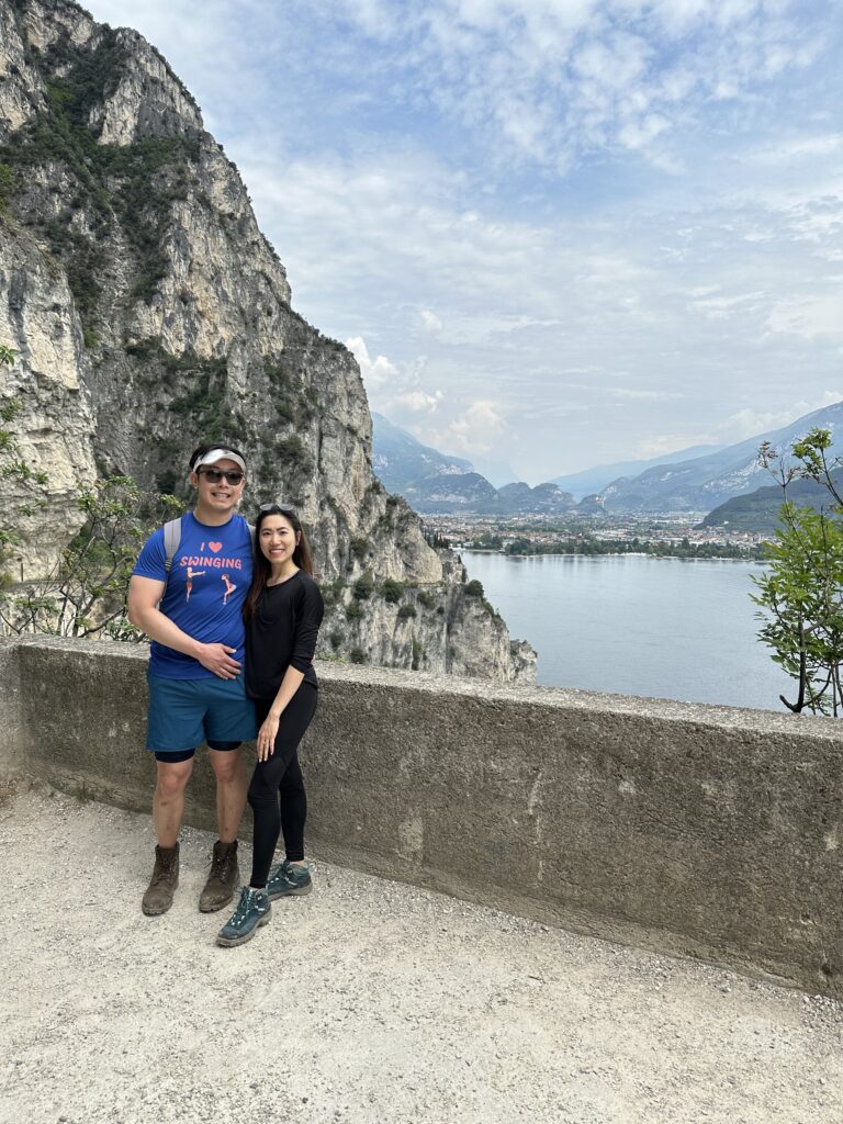 Ponale Path viewpoint with Lake Garda stretching below and alpine peaks in the distance