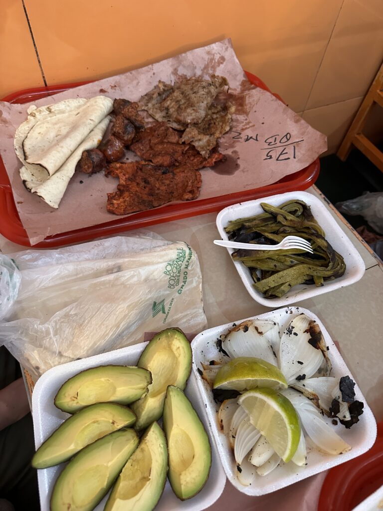Grilled meats and tortillas from Smoke Hall in Oaxaca, showcasing a flavorful mix of local cuisine and smoky delicacies