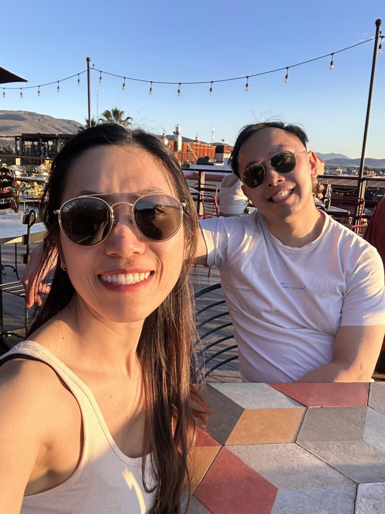 Enjoying drinks on a beautiful rooftop at Gozobi Restaurant Bar in Oaxaca, with stunning views and vibrant atmosphere