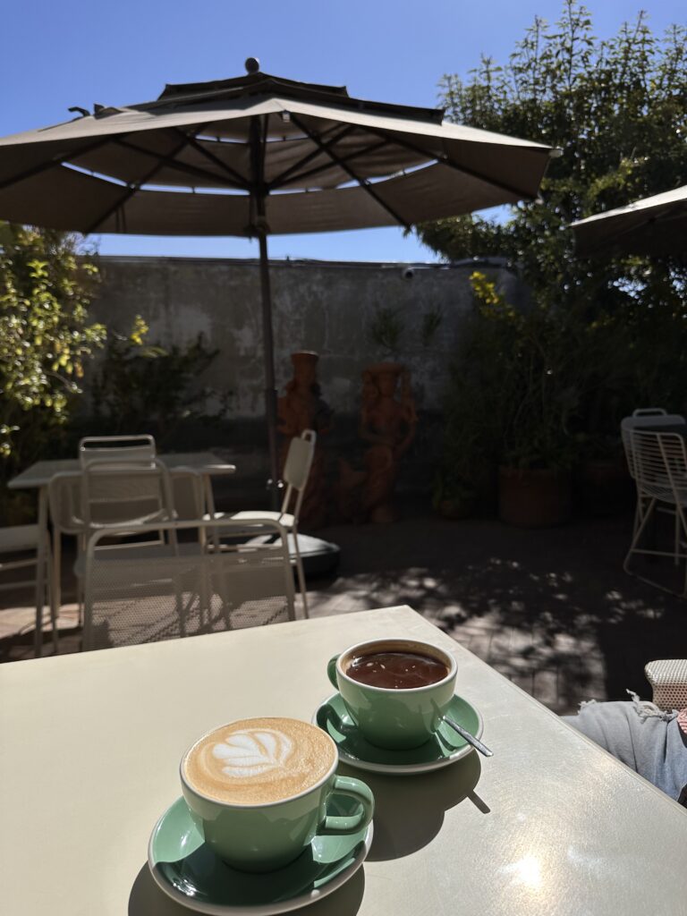 Enjoying a cup of coffee on a sunny terrace, soaking up the warm sunlight and relaxed ambiance in Oaxaca