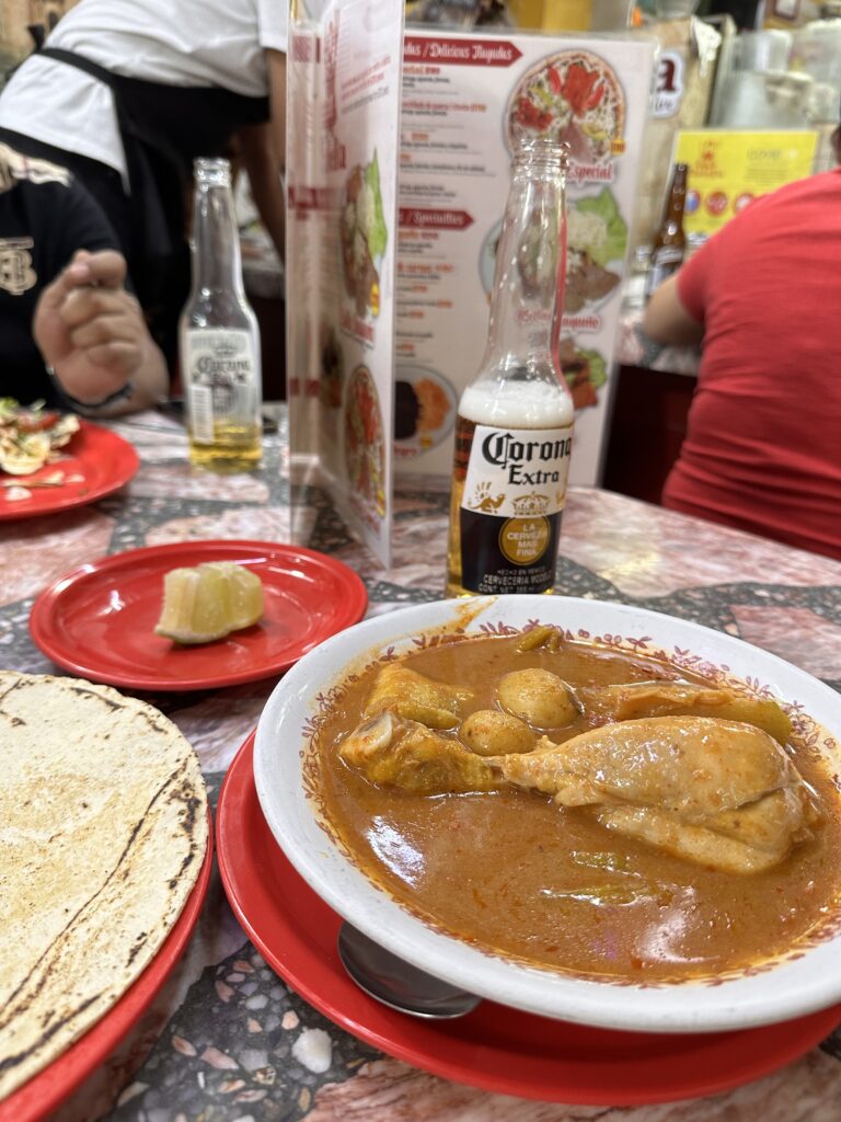 Delicious yellow mole with chicken thighs from Mercado 20 de Noviembre in Oaxaca, showcasing authentic local flavors and ingredients.
