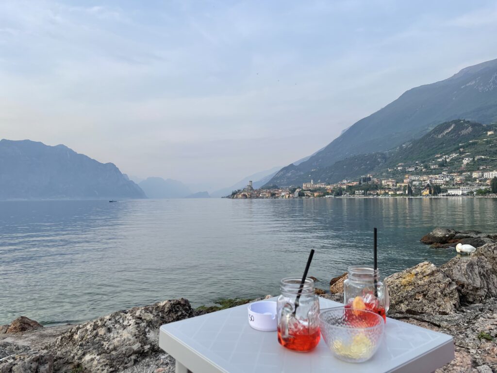 Lakeside bean bags at sunset with cocktails and scenic Lake Garda backdrop