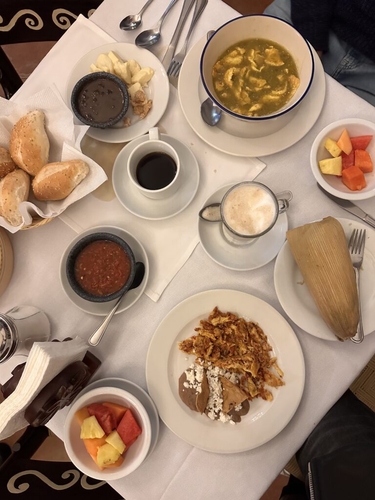 Enjoy a classic Mexican breakfast featuring a savoury tamale, scrambled eggs, and a rich, flavourful mole sauce that enhances every bite