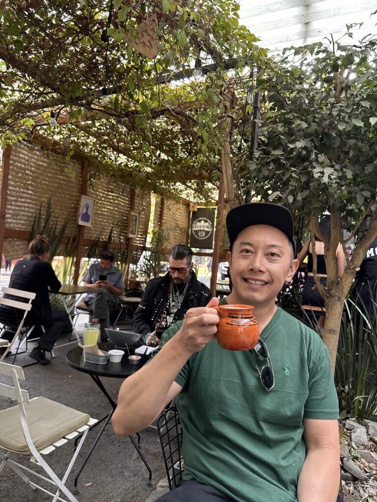 Janson enjoying fresh pulque served in a clay mug in Mexico City. Definitely a must try in your Mexico itinerary