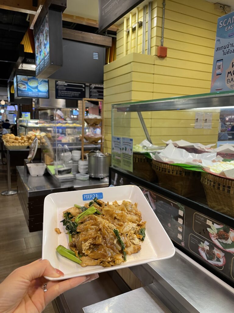 Dining at Pier 21 food court in Terminal 21 Bangkok, ordering Thai dishes from a variety of local food stalls
