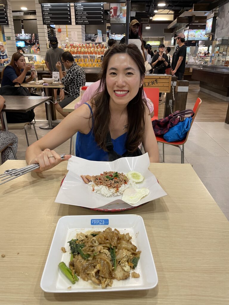 Sitting at a bench in Pier 21 food court, enjoying two delicious and affordable Thai dishes in Bangkok’s Terminal 21