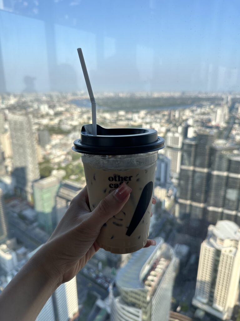 Enjoying a cup of coffee with panoramic views of the Bangkok skyline from the Mahanakhon Tower