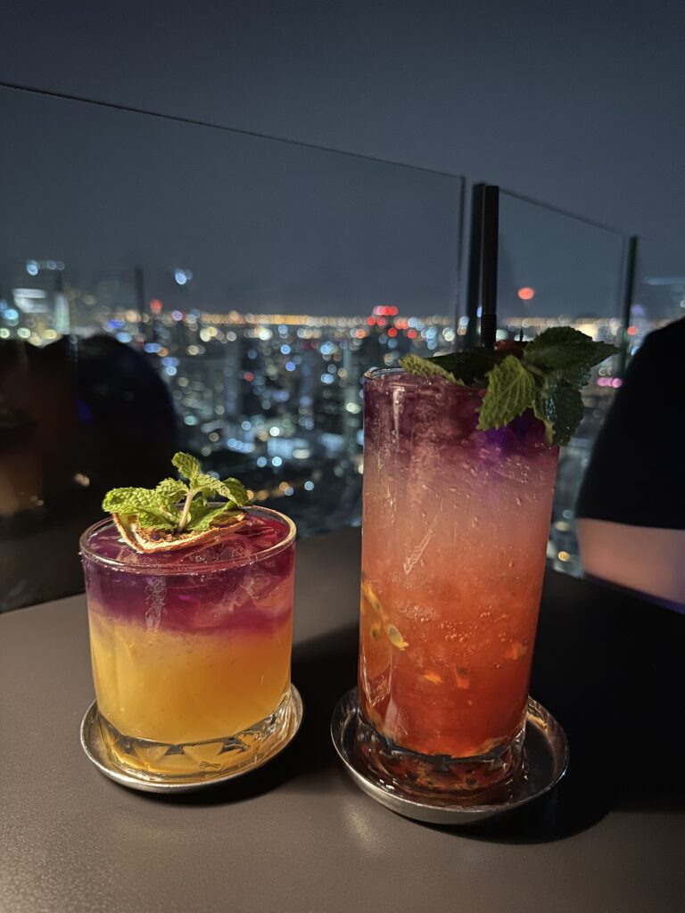 Cheers to great cocktails and breathtaking views at a rooftop bar, where the city buzzes below and the sky stretches above