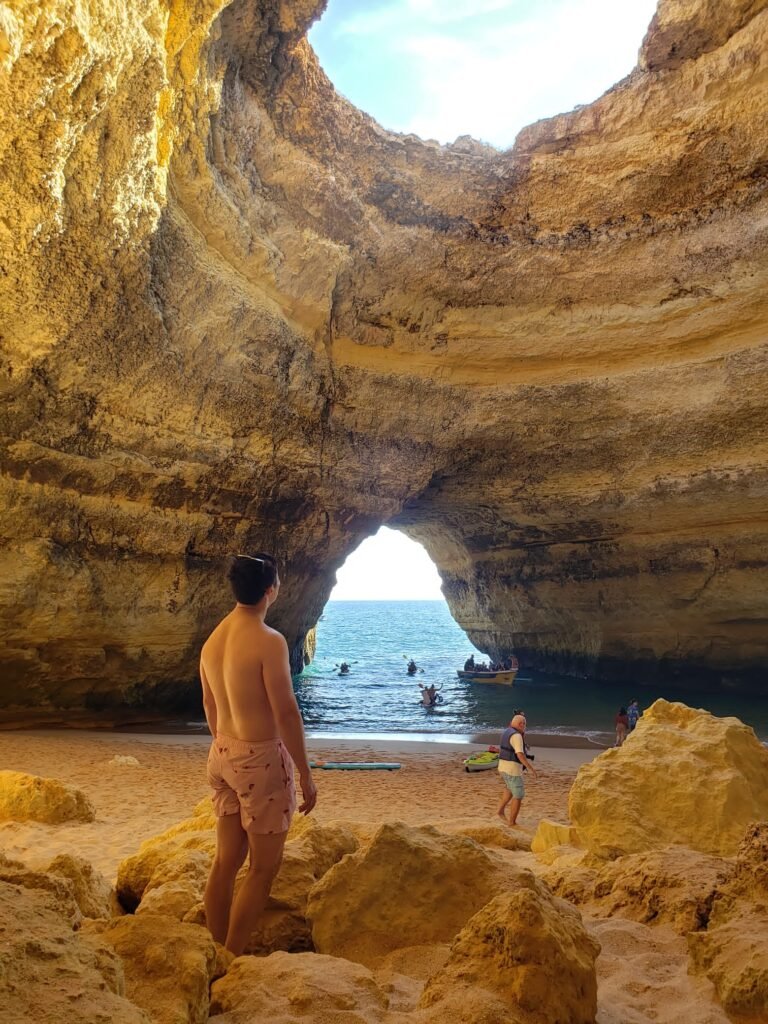 Inside view of the Benagil Cave with sunlight streaming through the iconic roof opening, Algarve, Portugal