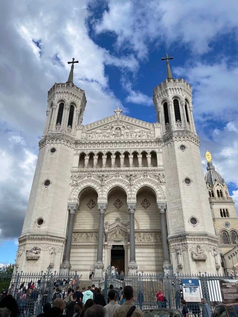 The grand exterior of the Basilica of Notre-Dame de Fourvière, located atop Fourvière Hill in Lyon, showcasing its intricate architecture and historical significance.