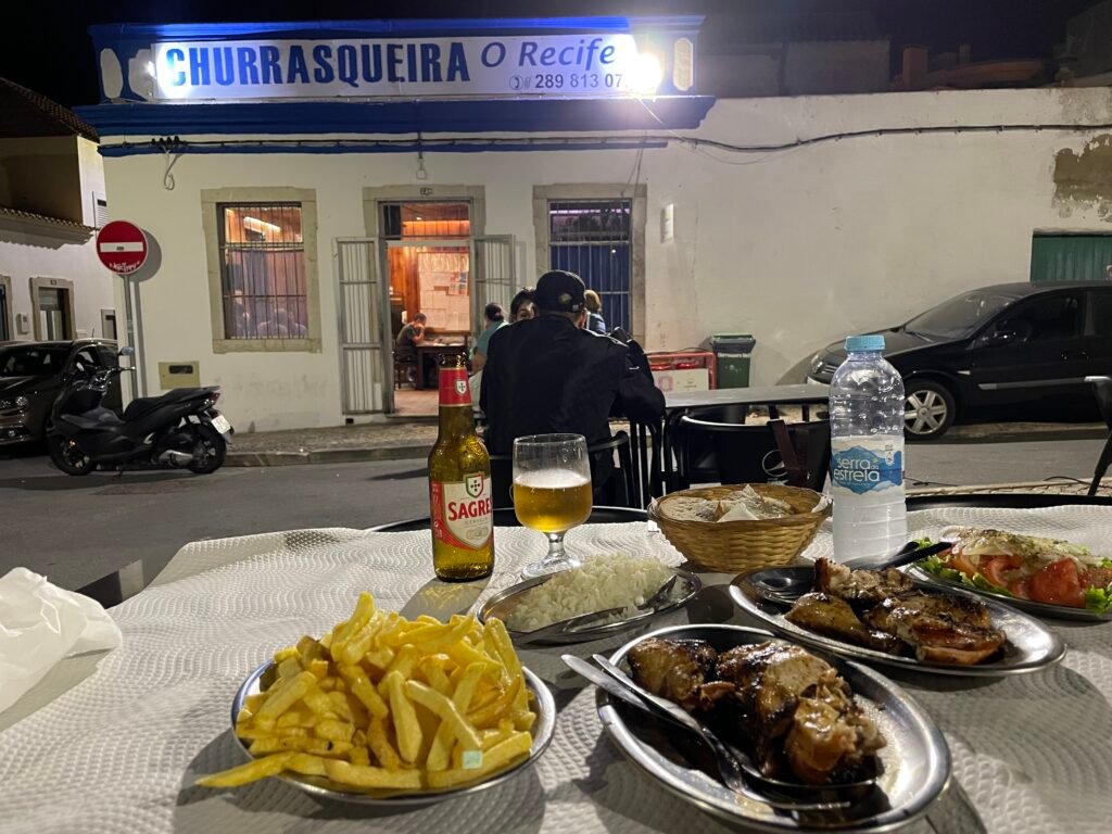 Spicy Portuguese piri piri chicken served with fries and salad at a traditional churrasqueira