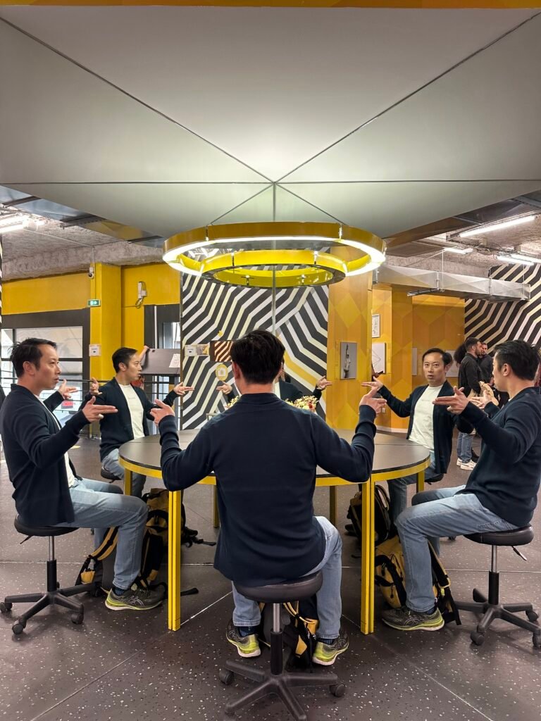 Visitors enjoying the interactive mirror room at the Museum of Illusions in Lyon, where reflections and angles create fascinating optical effects.