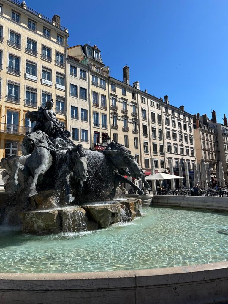 Close-up of galloping horses on the Bartholdi Fountain, a Lyon landmark by the creator of the Statue of Liberty