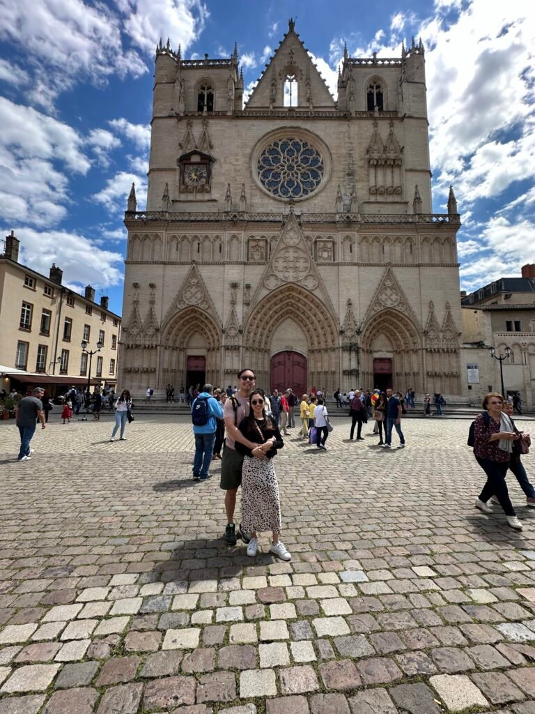 Tourists visiting the stunning Saint-Jean Cathedral in the heart of Lyon’s Old Town, admiring its Gothic design and impressive stained glass windows.