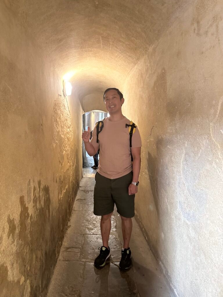 Stone corridor of a traboule in Vieux Lyon, showcasing medieval architecture and soft light