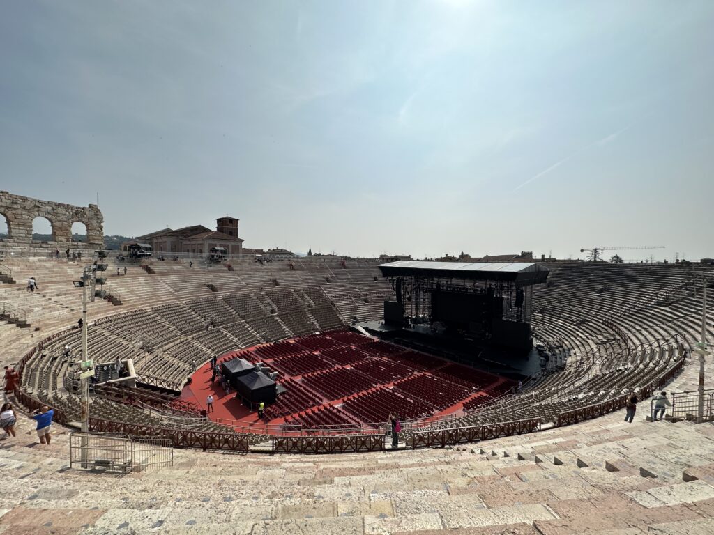 Inside Verona Arena with seating set up for an open-air opera performance