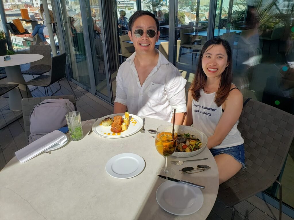 Couple enjoying a seafood meal with panoramic views at Restaurante Ria Formosa, Algarve