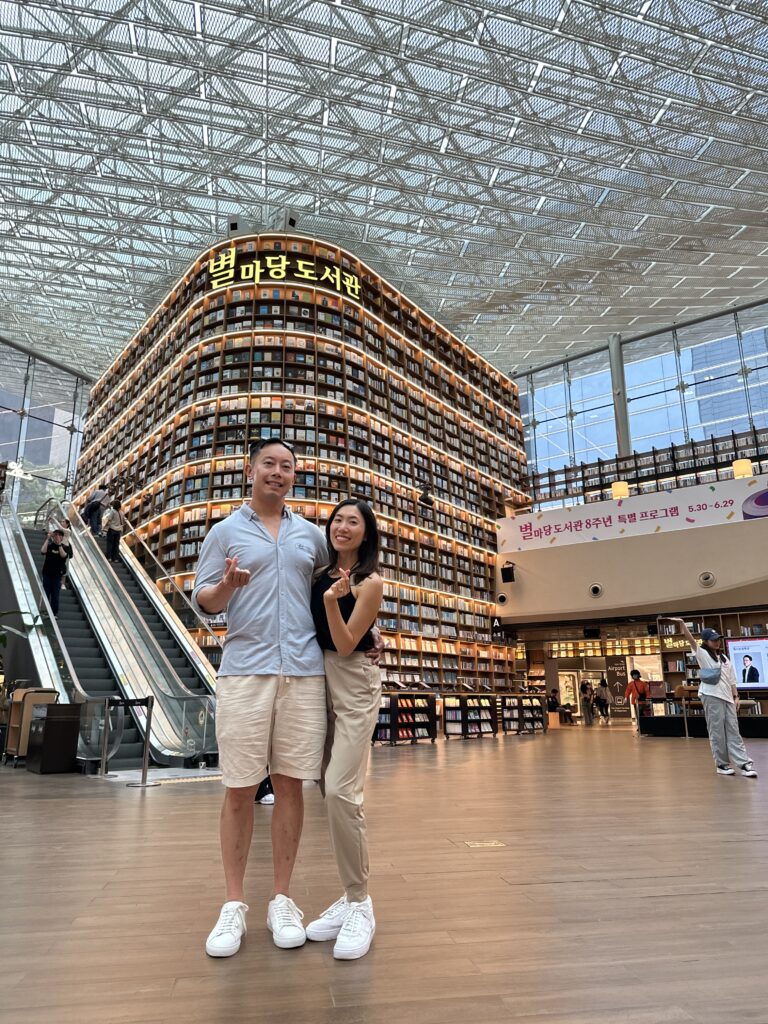 Visitors admiring the towering bookshelves inside Starfield Library, a modern Seoul landmark