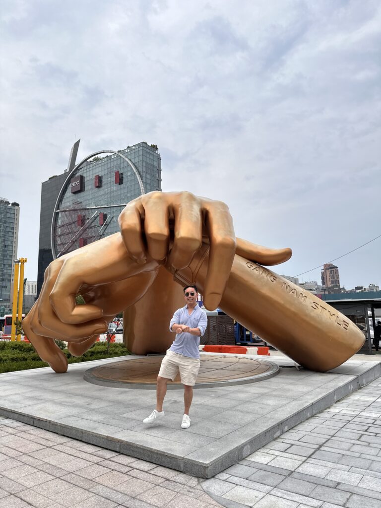 Iconic Gangnam Style statue capturing the famous dance move in a busy Seoul street
