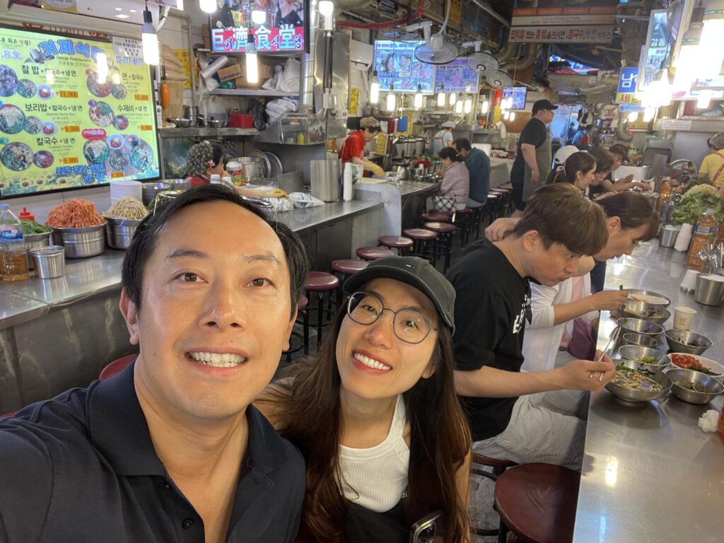 A bustling scene at Kalguksu Alley in Seoul, where diners enjoy traditional Korean knife‑cut noodles