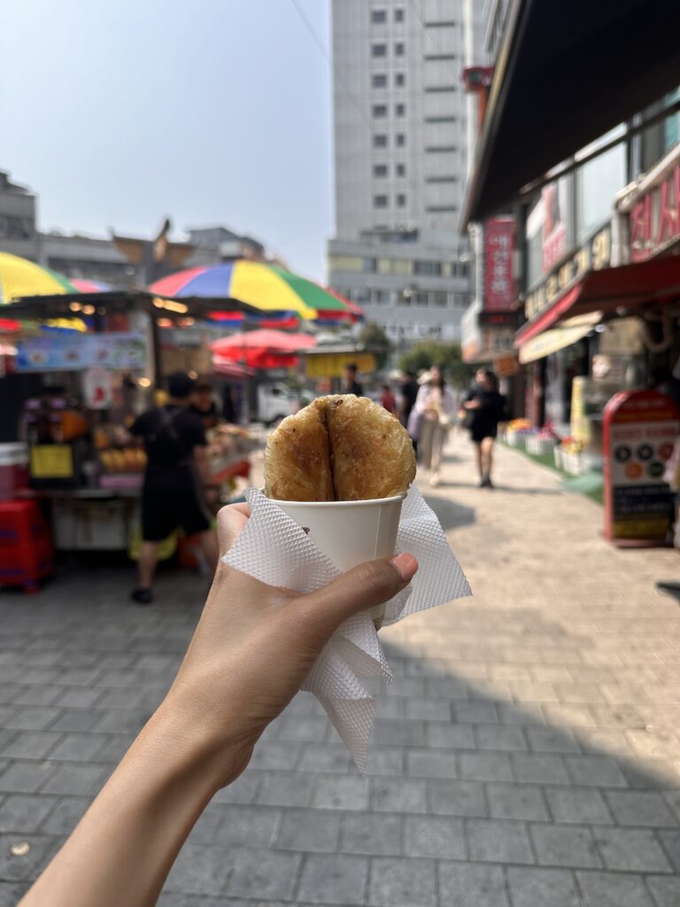 Freshly fried hotteok with a crisp exterior and sweet filling, a must‑try treat at Namdaemun Market in Seoul