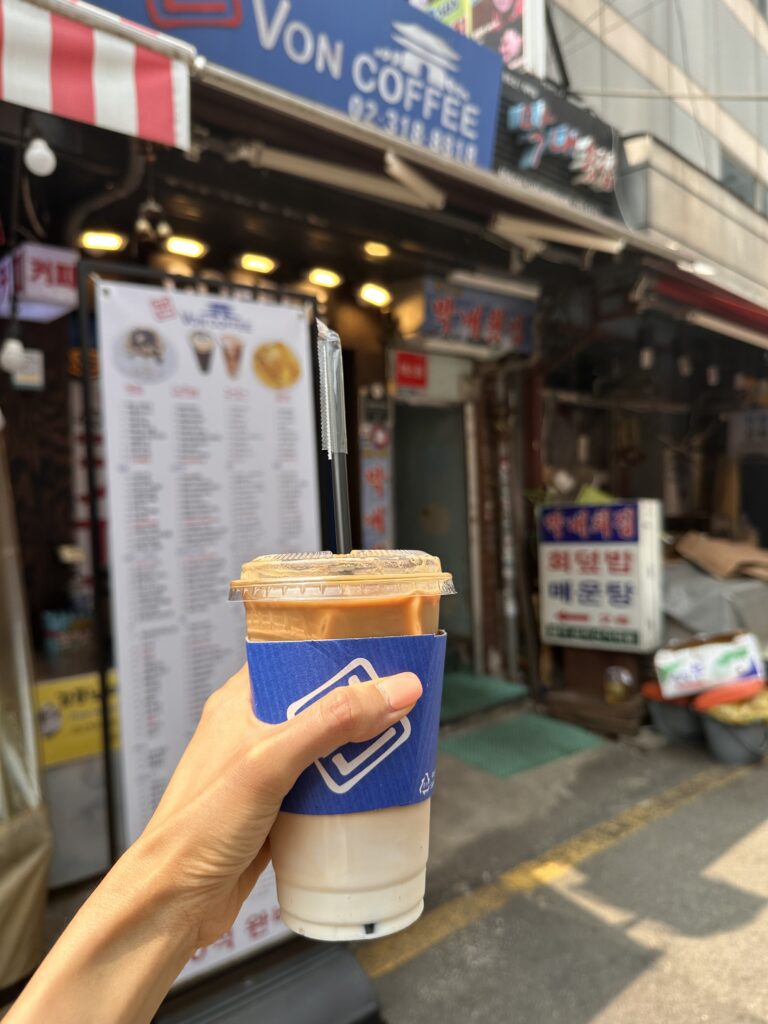 A refreshing iced latte in hand while exploring the bustling Namdaemun Market in Seoul
