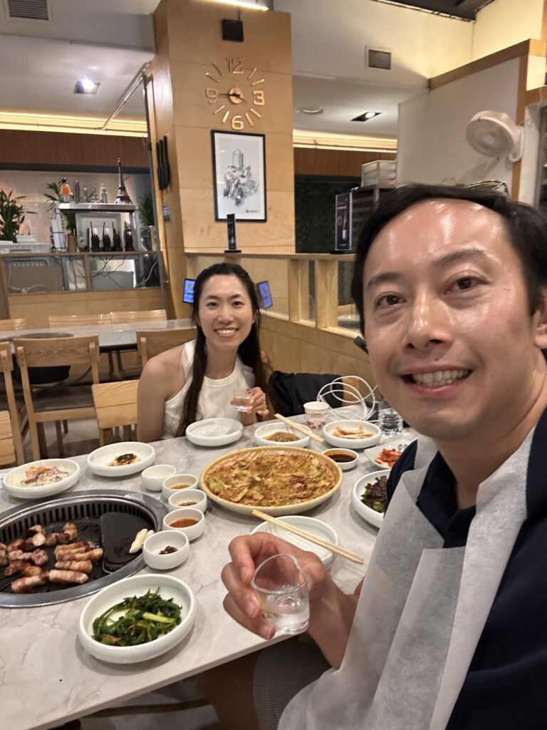 People toasting with soju while eating Korean BBQ in a popular Seoul barbecue restaurant