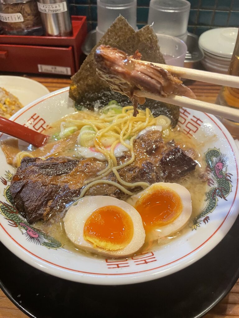 Hearty bowl of pork rib ramen with rich broth at Hanamaruken Hozenji Osaka