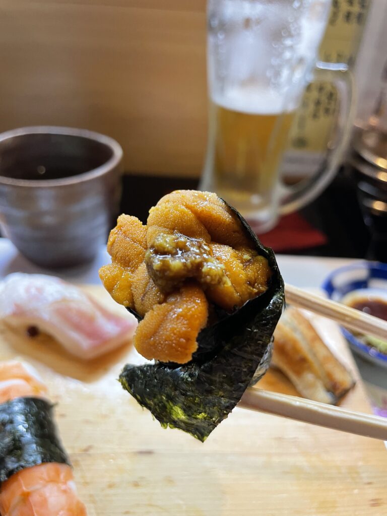 Fresh sea urchin sushi (uni nigiri) with its creamy texture and vibrant color.