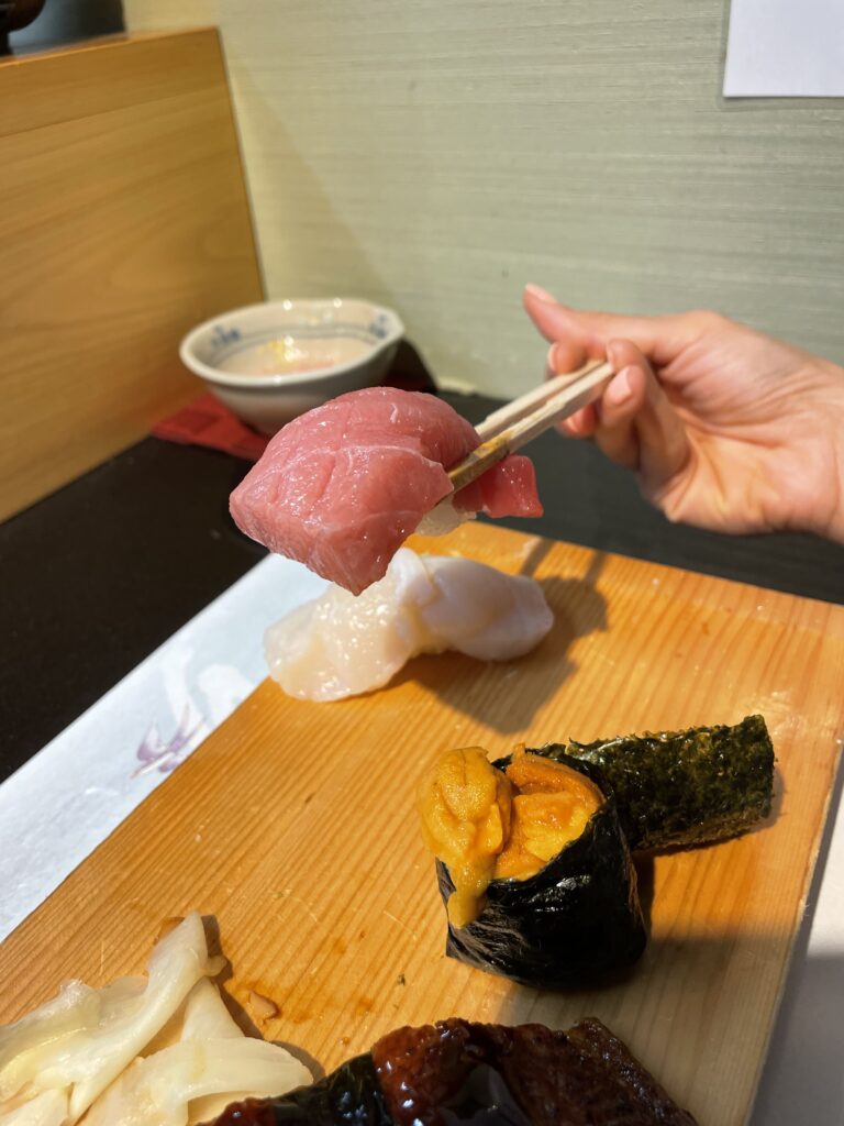 Guests enjoying an authentic sushi experience at Sushi Katsuya with fresh uni and scallop highlights