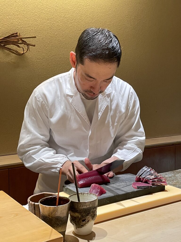 Head chef at Ichi-u Tokyo preparing omakase meal in front of guests