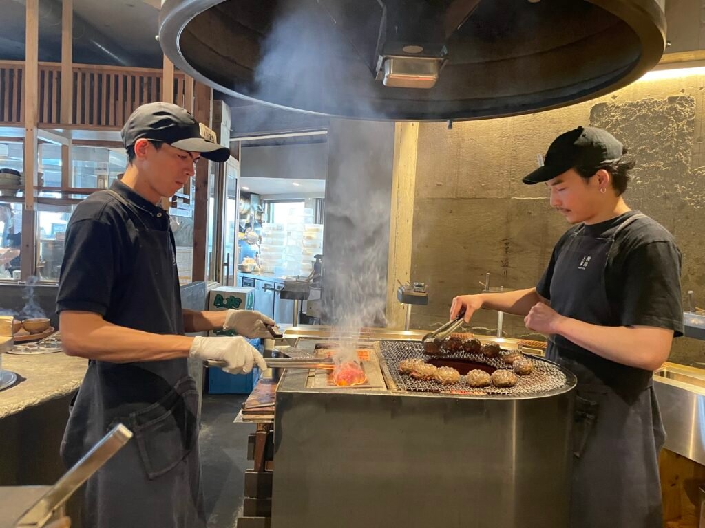 The chefs preparing the succulent beef patties at Hikiniku to Come, Shibuya, Japan