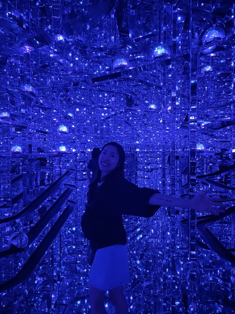 Travelers surrounded by vibrant digital art at TeamLab Borderless Tokyo