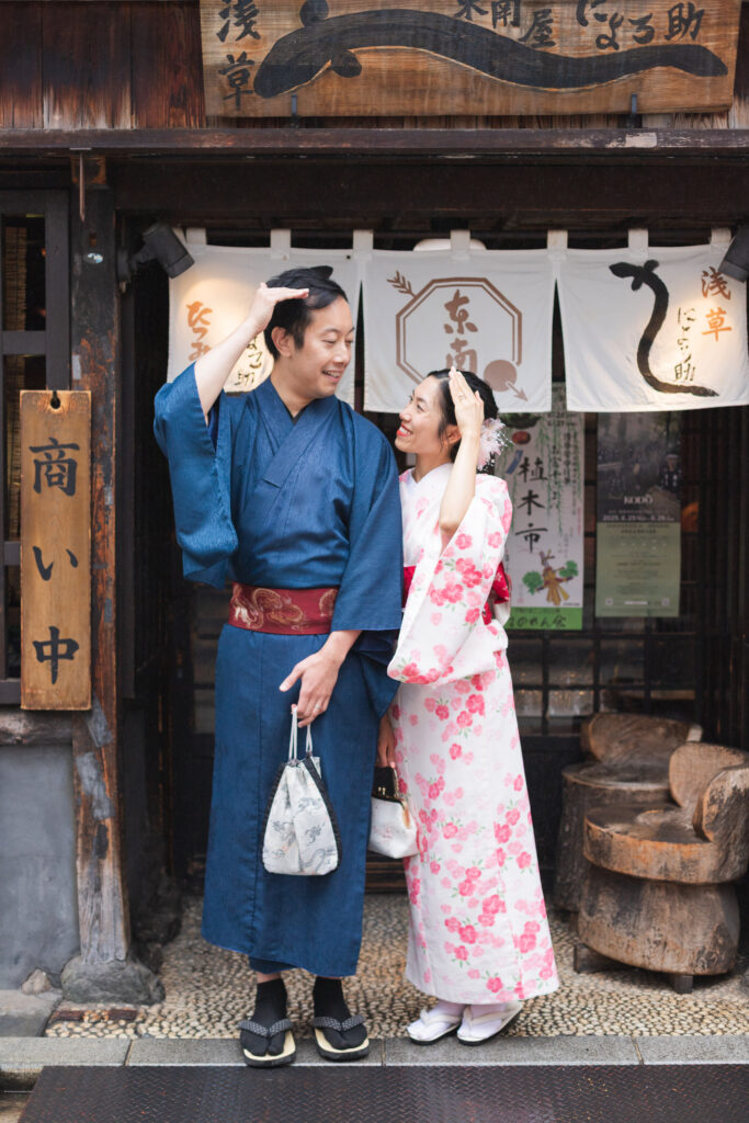Couple wearing traditional kimonos posing on the ancient streets in Asakusa Tokyo Japan