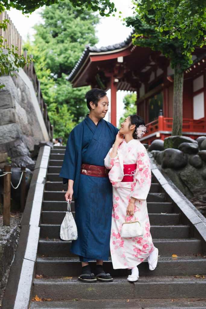 Couple wearing traditional kimonos posing in front of Senso-ji Temple in Asakusa Tokyo Japan