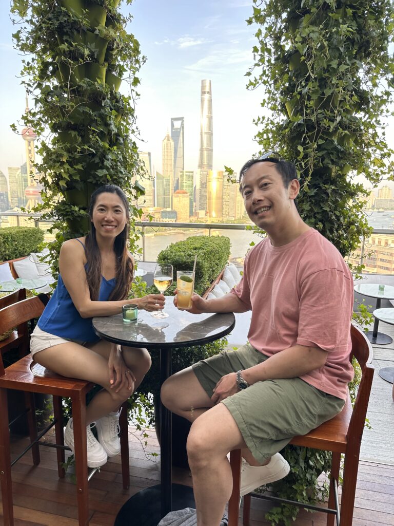 Guests enjoying cocktails with sweeping views of Shanghai skyline from EDITION hotel rooftop