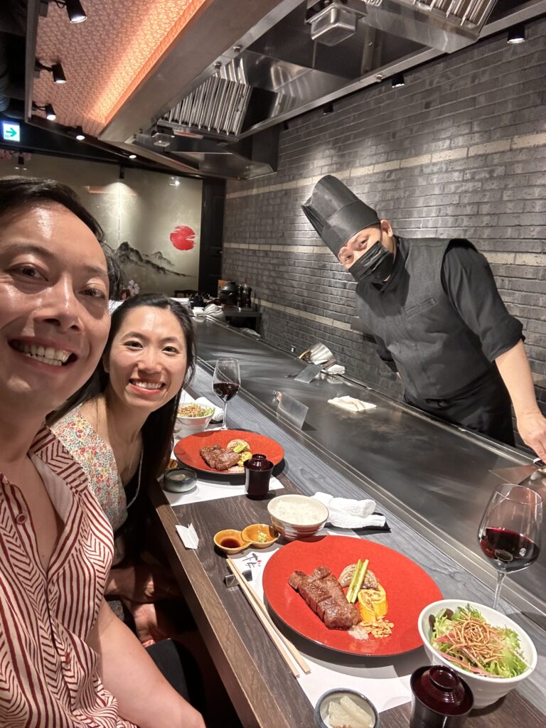Tourist enjoying a Kobe beef lunch set in a traditional Japanese restaurant prepared by the chef