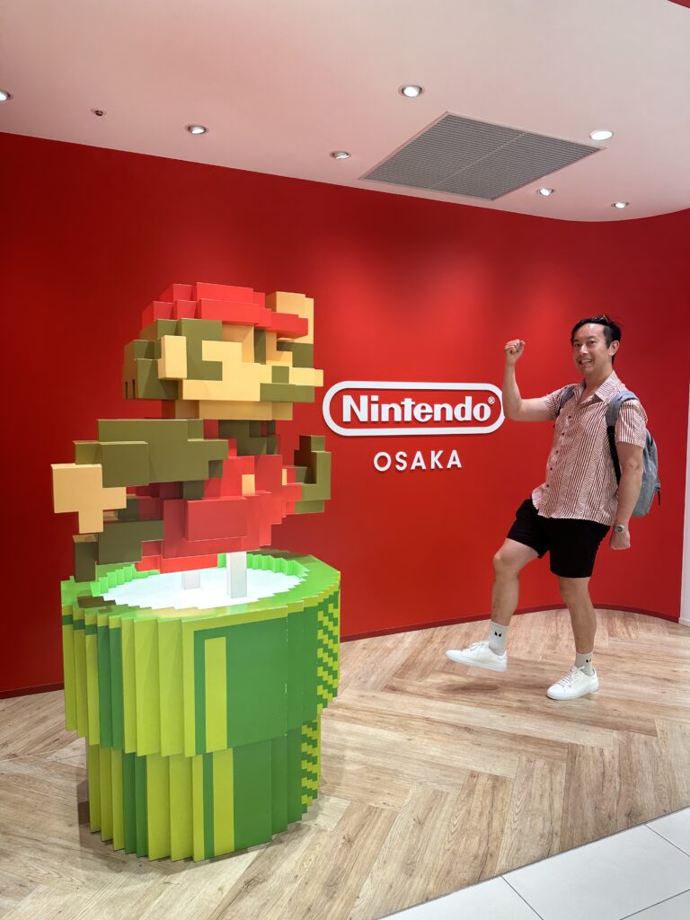 Interactive attractions at Super Nintendo World in Osaka, Japan, surrounded by life-sized Mario characters and game-inspired elements.