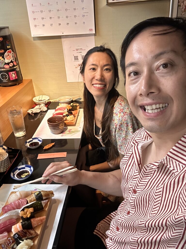 Guests enjoying an authentic sushi experience at Sushi Katsuya with fresh uni and scallop highlights