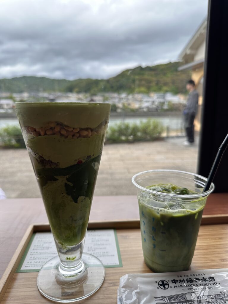 Colourful matcha parfait with layers of ice cream, jelly, and fresh fruits